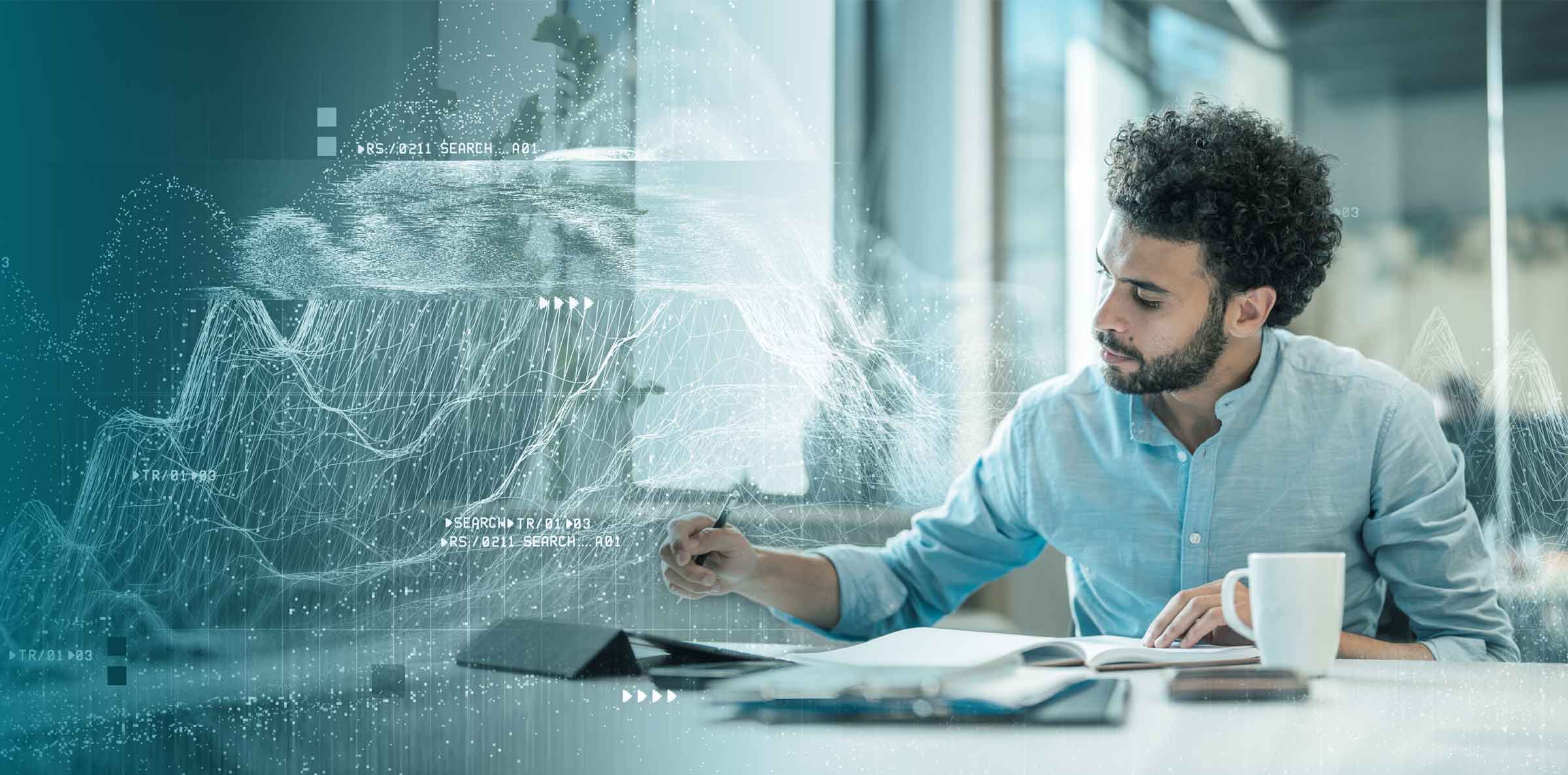 Man working at desk surrounded by data