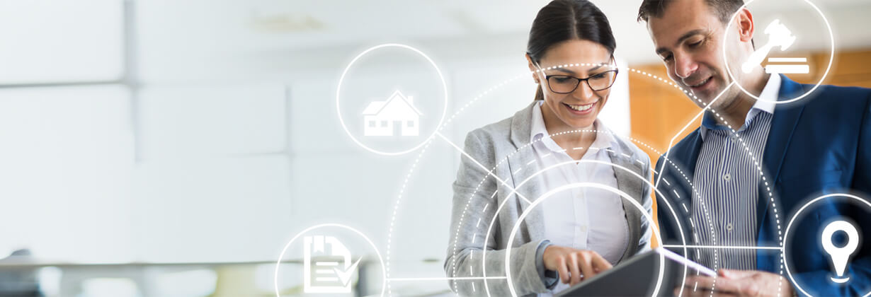 Woman and man looking at tablet at work 
