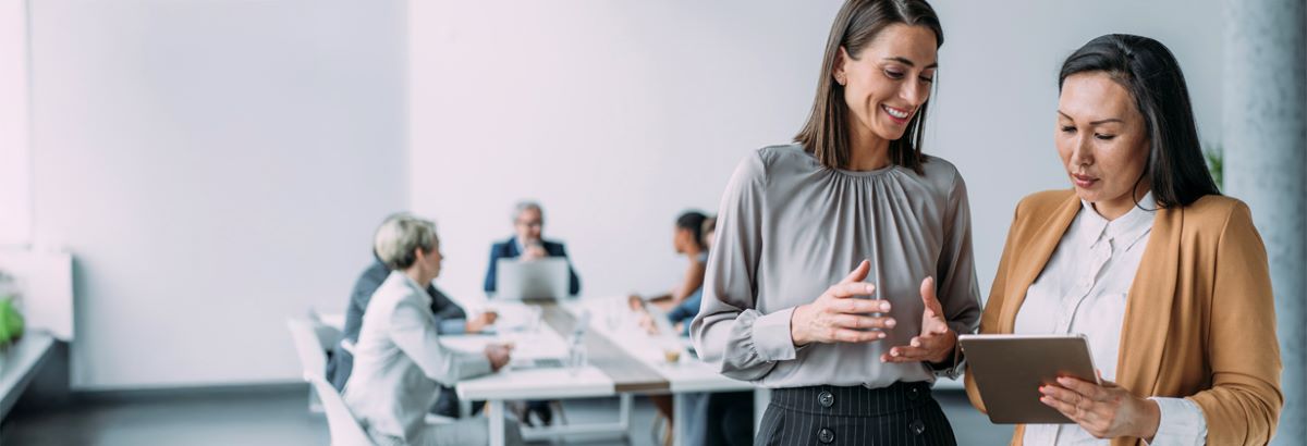 Women on tablet in meeting