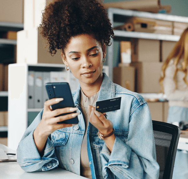 woman entering credit card info on mobile phone