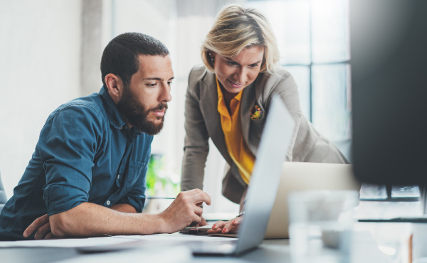Women and Man looking at laptop