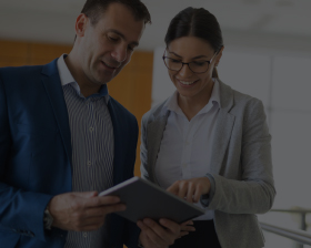 Man and women at work looking at paper
