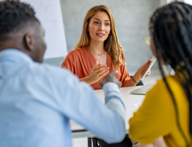 2 women and a man in a meeting