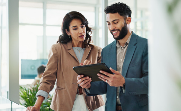 Woman and man on tablet