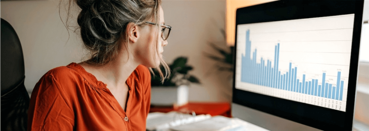 woman reviewing customer acquisitions document