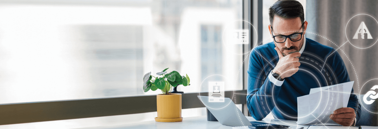 Man looking at paperwork with data points