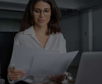 Woman at work looking at papers