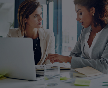 Women looking at work documents at work