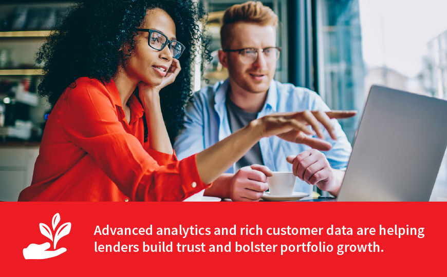 Woman and man pointing to computer screen