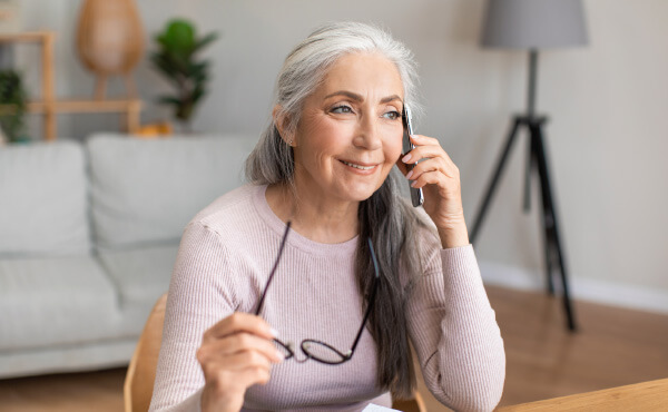 old woman in living room on the phone