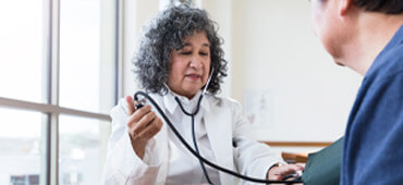 Doctor taking blood pressure