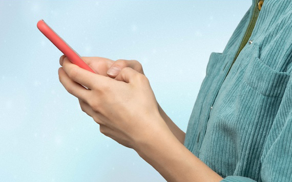 Hands holding mobile device 