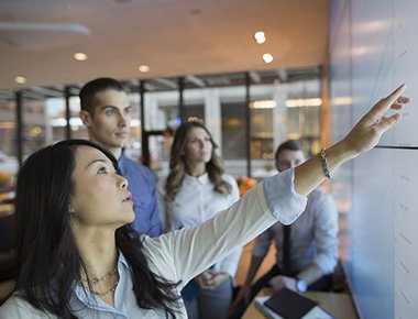 woman pointing at whiteboard
